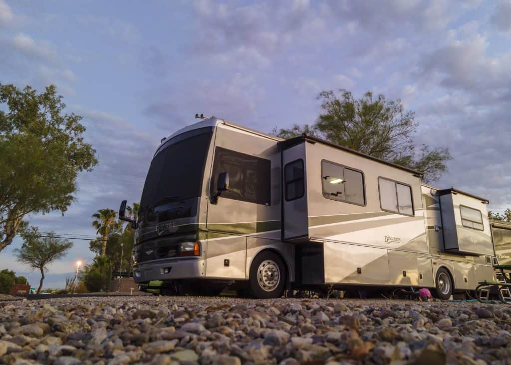 RV parked under cloudy Tucson sky