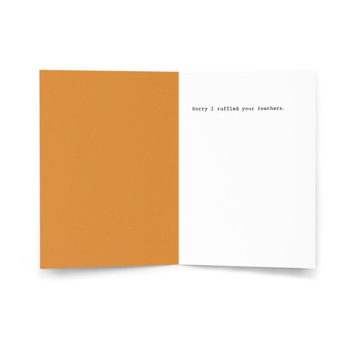 Open greeting card with handwritten message "Sorry I ruffled your feathers.".