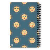 Bright sun and moon face pattern on a spiral notebook cover, cheerful summer-themed design.