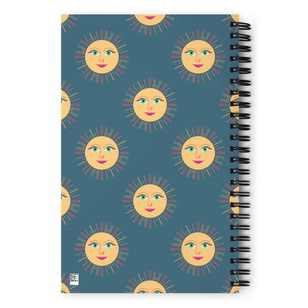 spiral-notebook-white-back-690e28f81606a.jpg Bright sun and moon face pattern on a spiral notebook cover, cheerful summer-themed design.